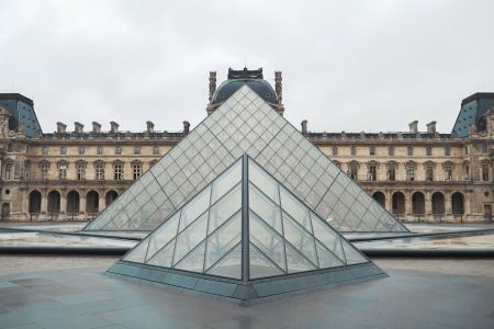 gray concrete building near fountain louvre museum